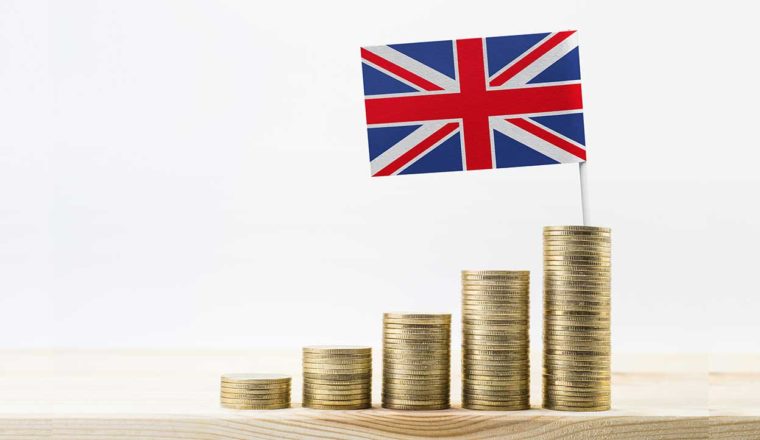 Stacks of coins topped by a UK flag