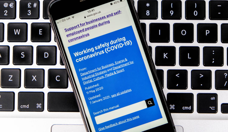 Mobile phone displaying government Covid support website