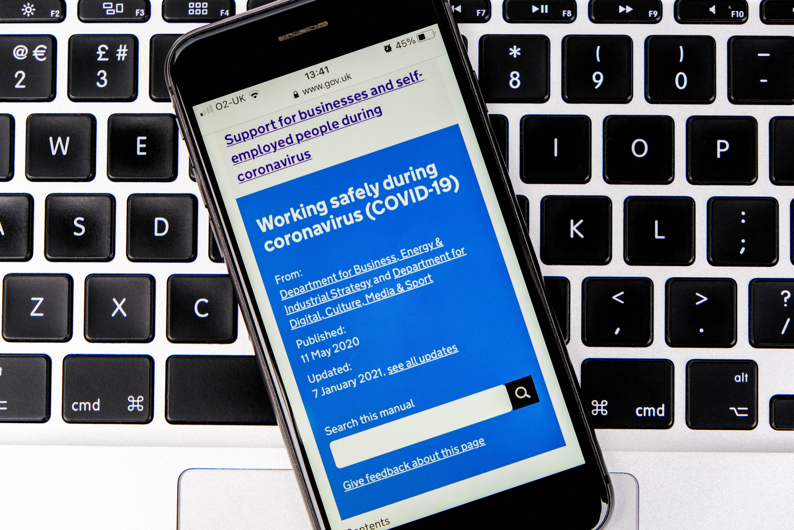 Mobile phone displaying government Covid support website