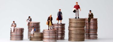 Figures standing on different piles of money