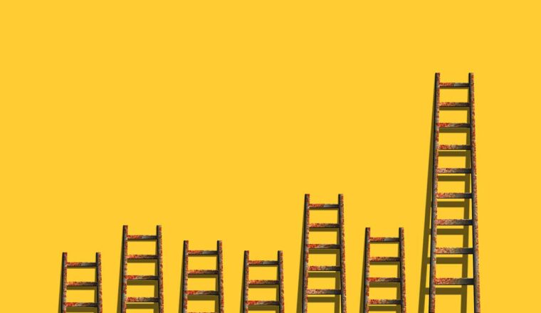 Image of ladders against a yellow wall